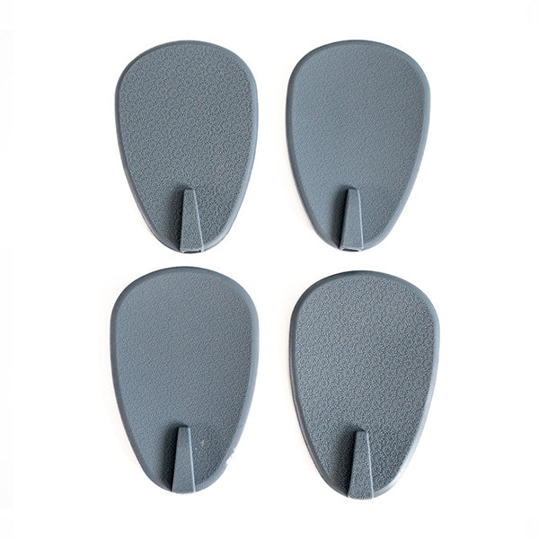 Four gray wall rubber paddles for gripping during exercise.